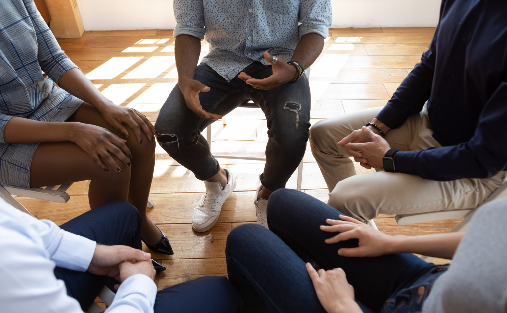 Image of a the legs of a group of people sitting in a circle | for what makes an effective mental health clinician