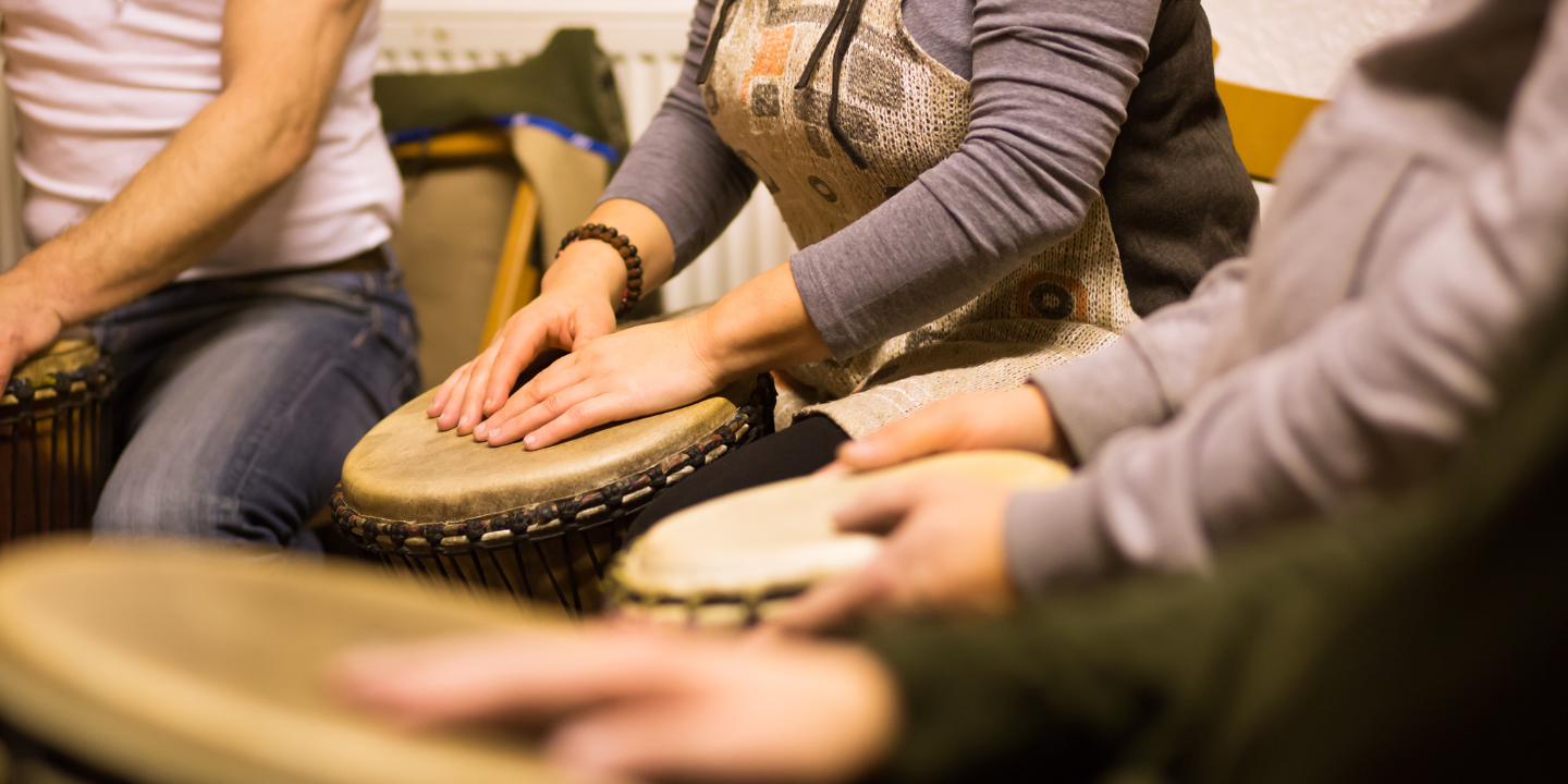 Image of hands on djembes as the hero image for the blog Drum Circles in Substance Use Disorder Treatment