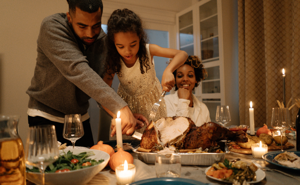 loving someone with substance use disorder | father and daughter carving a turkey with woman in the background